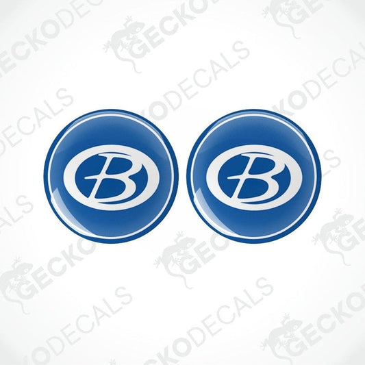 Two blue vinyl decals with a white 'B' logo, dome-shaped with a glossy finish.