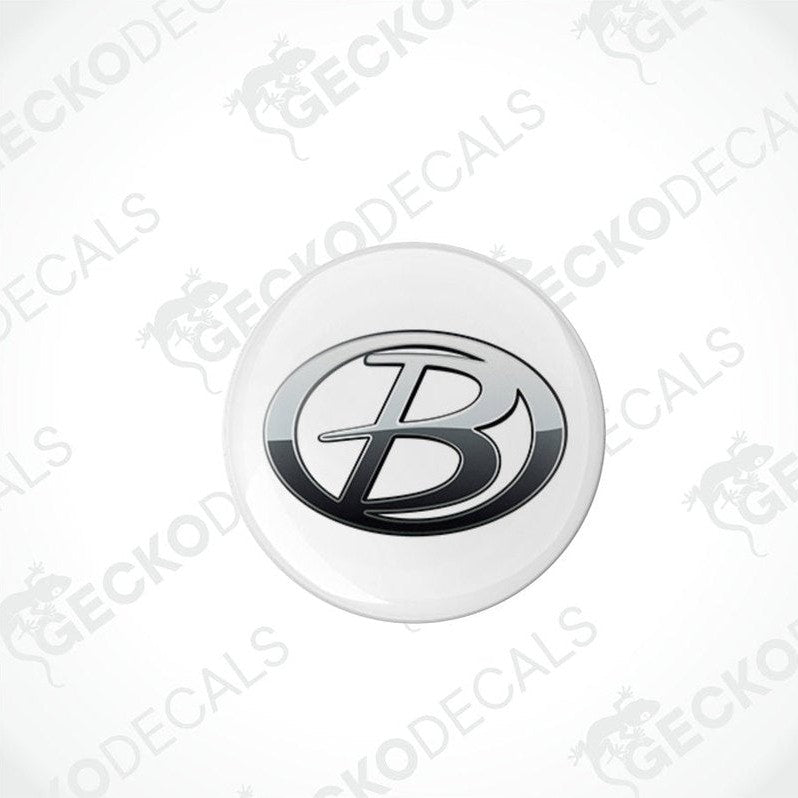 round white vehicle decals with a black 'B' logo in the center, placed on a patterned background.