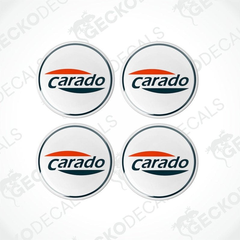 A set of four white vinyl decals with the 'CARADO' brand logo in orange and blue.