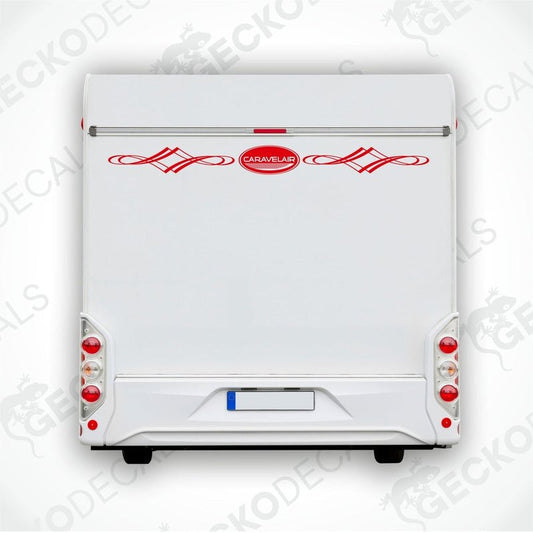A white caravan with a red decorative decal on the rear side.