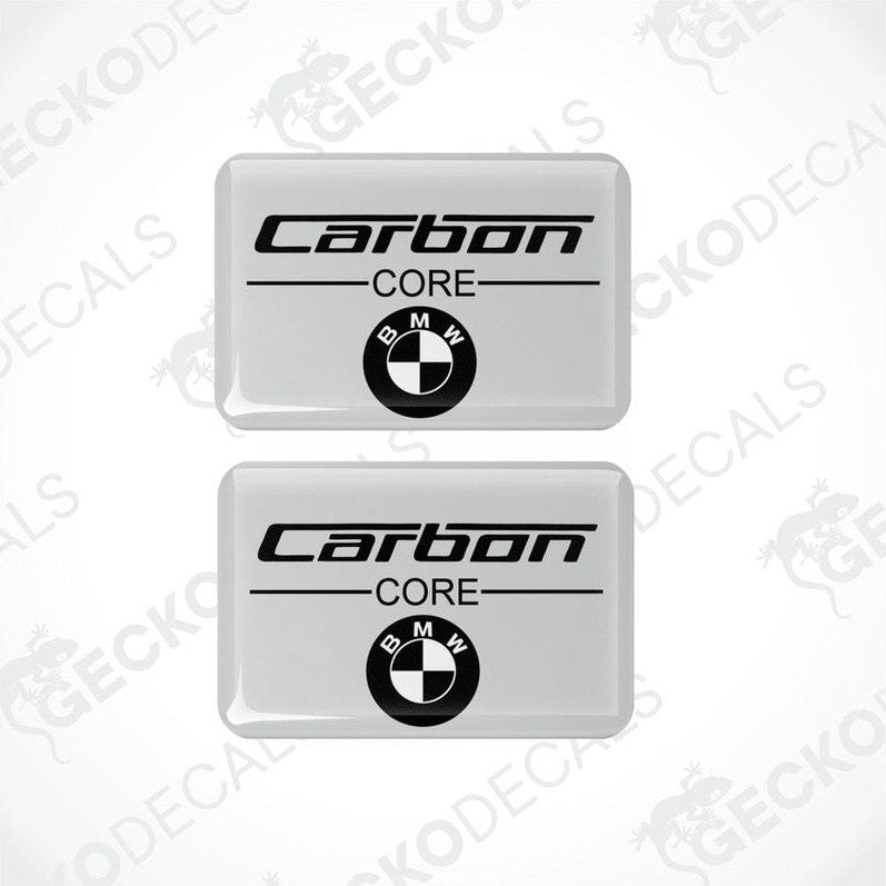 Two rectangular car decals with the words 'Carbon CORE' and the BMW logo