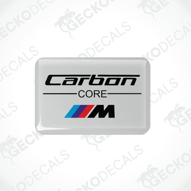 White vinyl stickers with the text 'CARBON CORE' and a BMW 'M' logo on a white background.