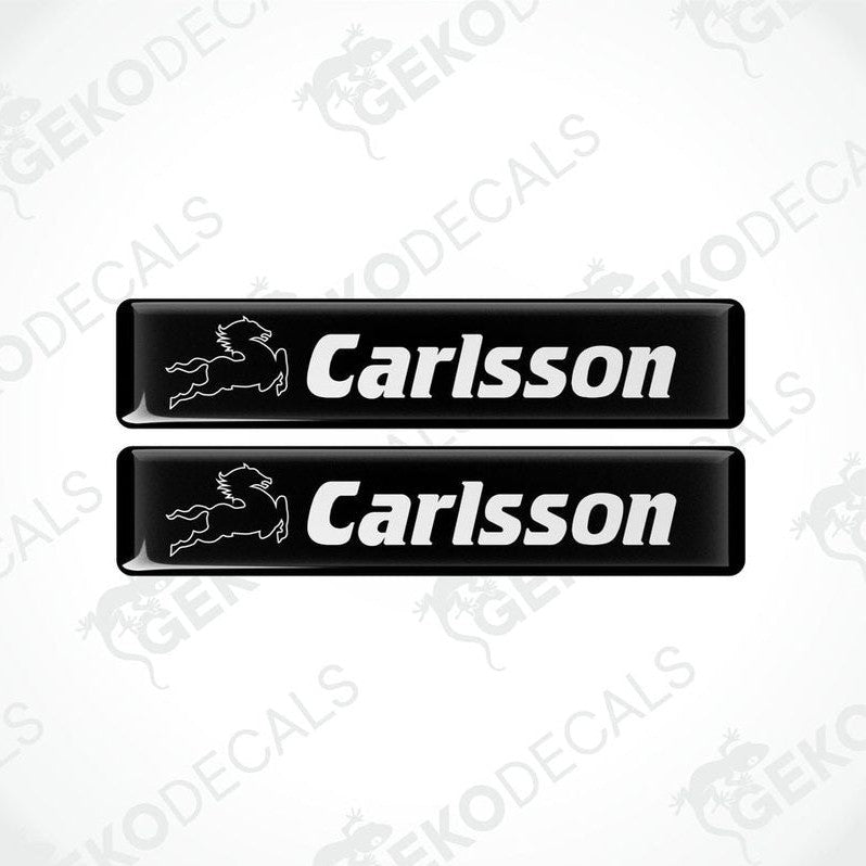 Two black vinyl decals with the text 'Carlsson' and a logo on them.