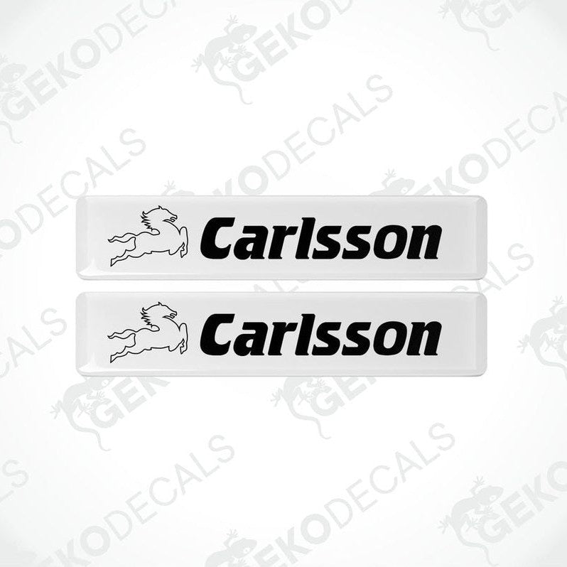 Two white vinyl decals with the text 'Carlsson' and a logo on them.