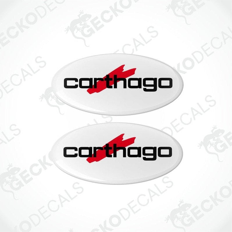 Two white vinyl stickers with the red text 'CARTHAGO' and a black logo symbol on them.
