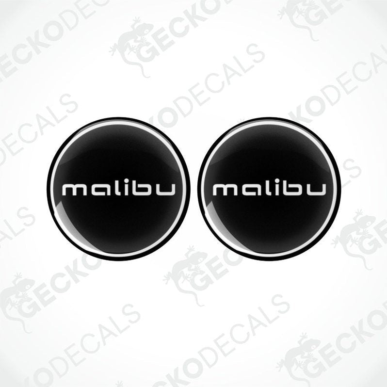 Two round black vinyl decals with the word 'malibu' written in white letters.