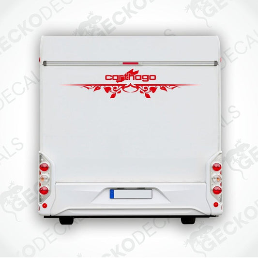 A white caravan with a red floral pattern decal on the rear side.
