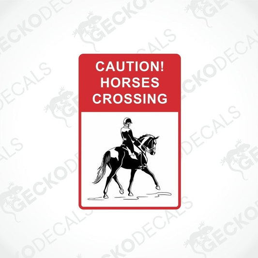 A rectangular decal with a white background and red text that reads 'CAUTION! HORSES CROSSING' along with a black and white illustration of a horse and rider.