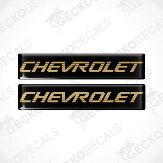 Two black vinyl stickers with the word 'CHEVROLET' in gold lettering, placed against a white background.