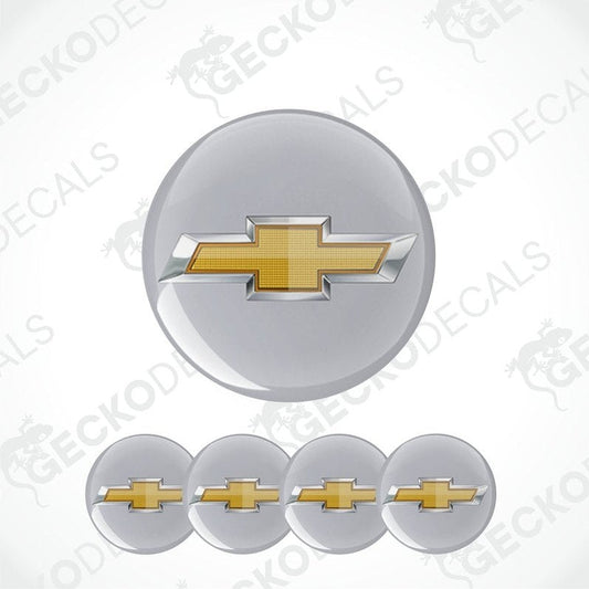 Set of five round metallic emblems with a gold and silver chevron design on a white background.
