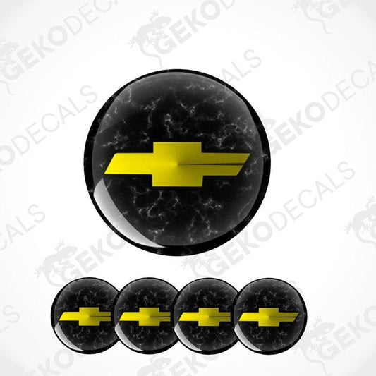 A set of four black vinyl stickers with a yellow chevrolet logo, designed for use on car wheels or caps.