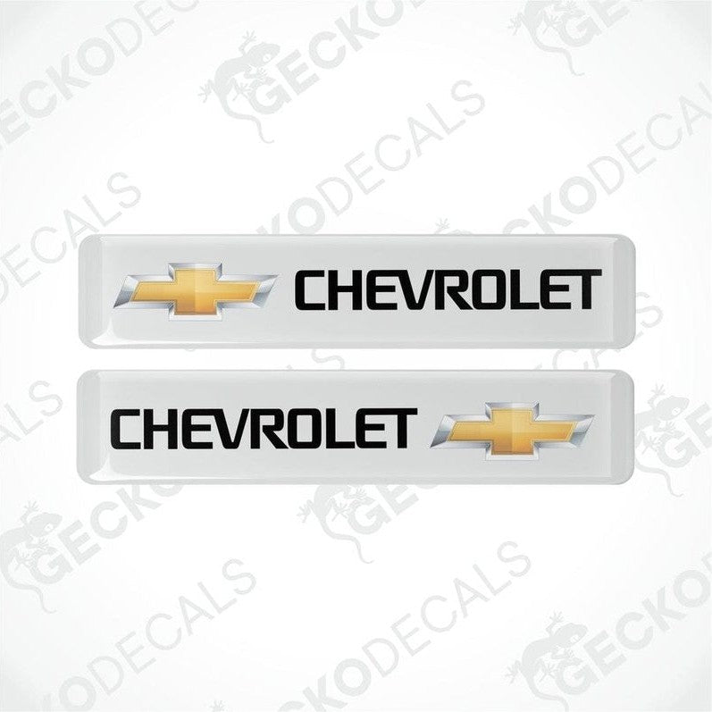 Two white vinyl decals with the Chevrolet logo in yellow.