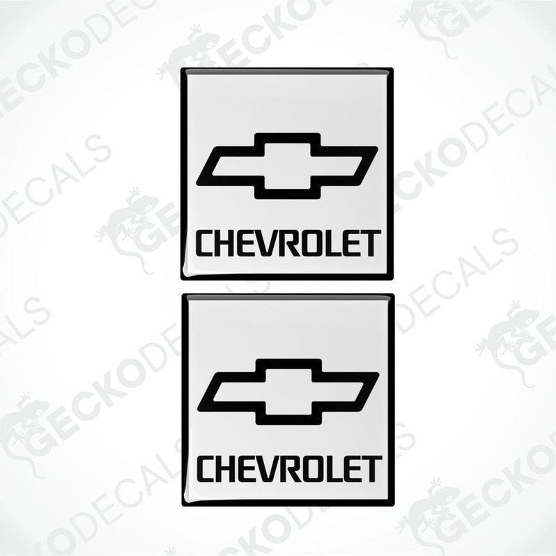Two white and white vinyl stickers with a black Chevrolet logo.