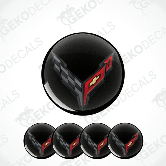 Set of black wheel center caps with red and gray design on a white background