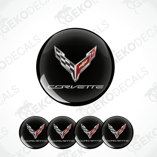 A set of four black vinyl stickers with the Chevrolet Corvette logo, including a design with red and white accents.