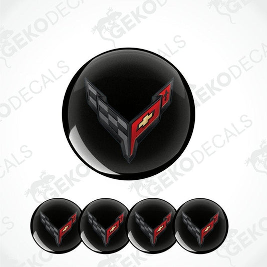 A set of four black vinyl stickers with a red and white geometric pattern design, resembling a car logo, displayed on a white background.