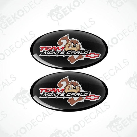 Two round vinyl stickers with a team monte carlo logo, predominantly black with red and white text and a cartoonish character.