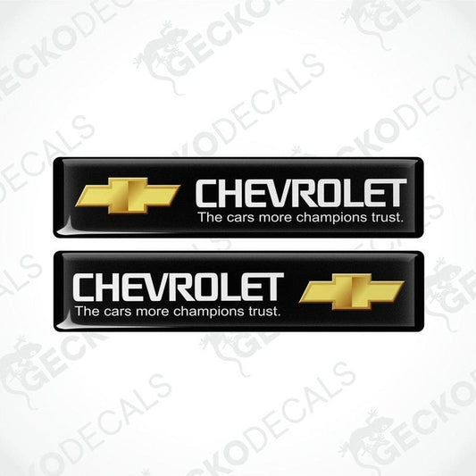 Two black vinyl stickers with the Chevrolet logo in white and a slogan 'THE CARS MORE CHAMPIONS TRUST'.