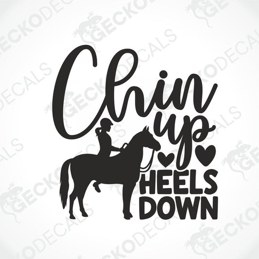 A black and white die cut decal with the text 'CHIN UP HEELS DOWN' and an illustration of a person riding a horse.