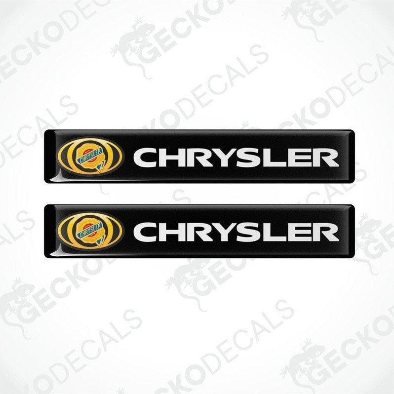 Two black vinyl decals with the Chrysler logo in yellow and white.