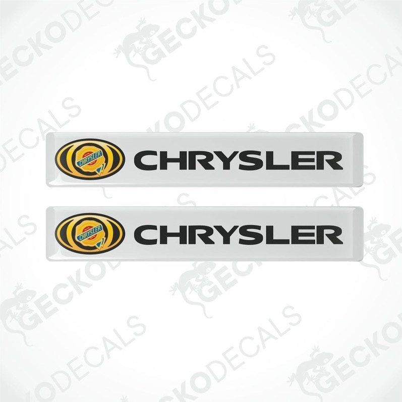 Two white vinyl decals with the Chrysler logo in yellow and black.