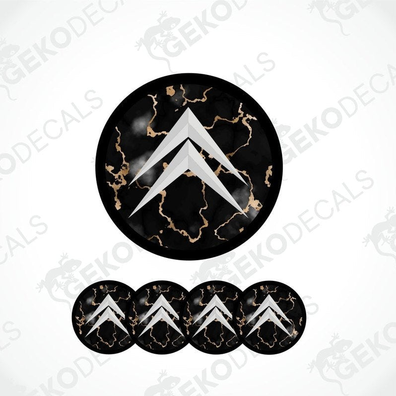 A set of four black vinyl stickers with a gold-colored design, arranged on a white background. Each sticker has a domed shape with a distinctive pattern and the brand 'CITROEN' marked on the top.