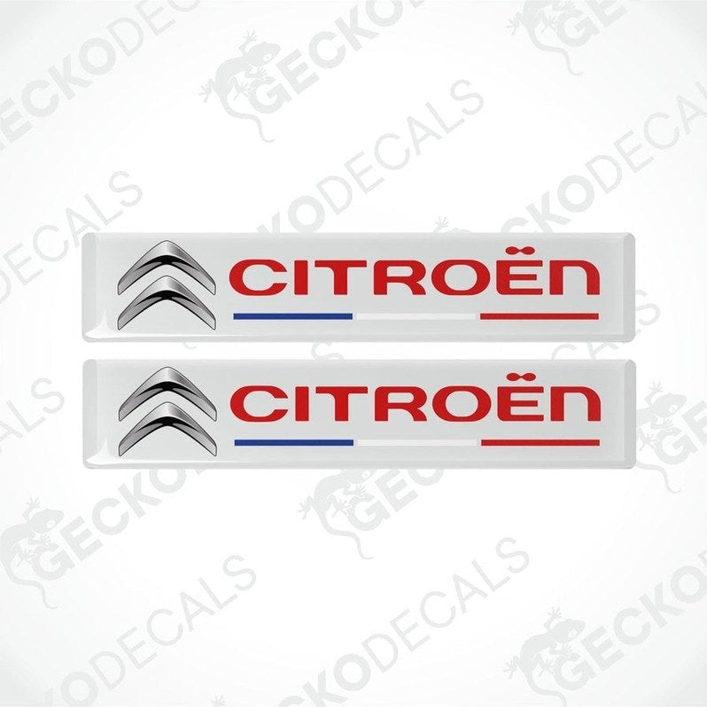Two rectangular vinyl decals with a polyurethane coating featuring the CITROEN brand logo in red and silver on a white background. The decals have a glossy finish.