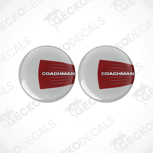 Two round white vinyl decals with the red text 'COACHMAN' on them, placed on a white background.