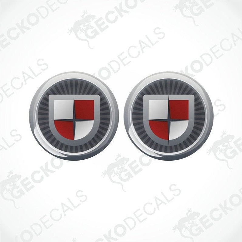 Two round vehicle decals with a shield design and the text 'COACHMAN' on them.