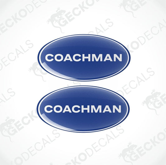 Two blue oval-shaped vinyl decals with the word 'COACHMAN' written in white letters.