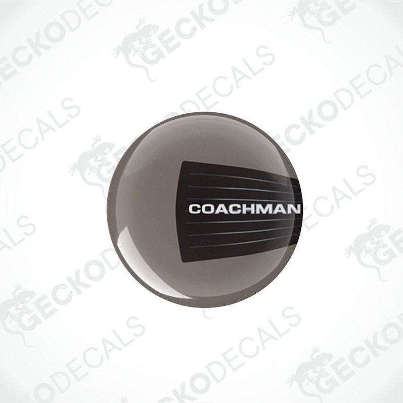 Two round black and white vinyl decals with the text 'COACHMAN' on them, placed on a transparent background.