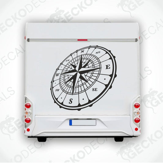 A white vehicle decal featuring a black compass design.