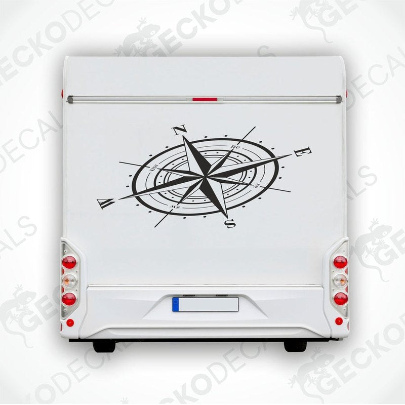 A white vehicle decal featuring a black compass design.