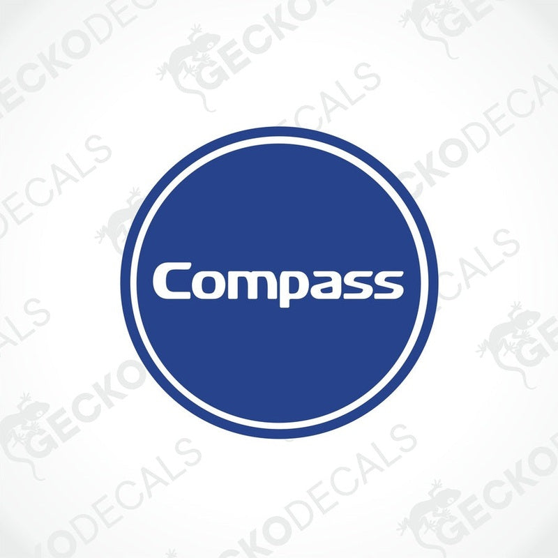 A circular blue and white sticker with the word 'Compass' in the center, resembling a compass logo.