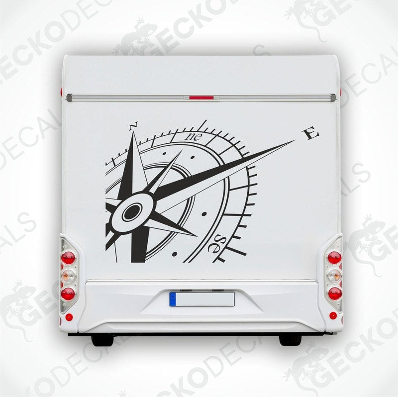 A white vehicle decal featuring a black and gray compass design.