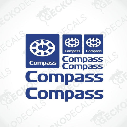 A set of three blue compass-branded decals, including two larger logos and two smaller text decals, with the word 'GECKODECALS' visible in the corner.