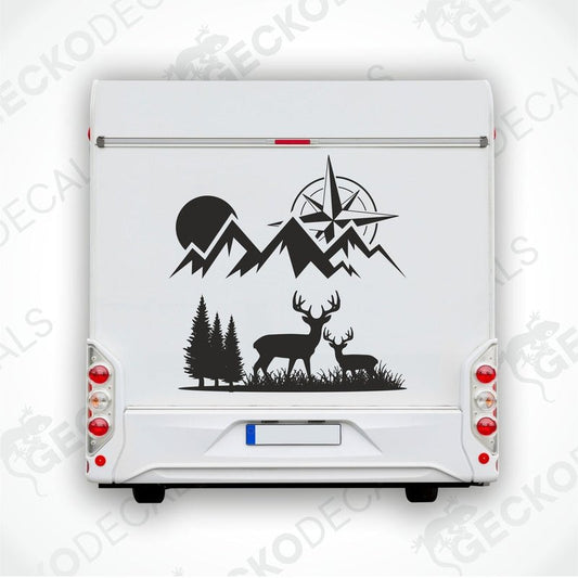 A black and white decal of a compass with mountains and deer on the front of a white vehicle.