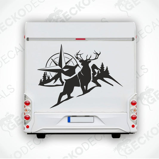 A black and white decal of a compass with mountain and forest background, and a deer in the foreground.
