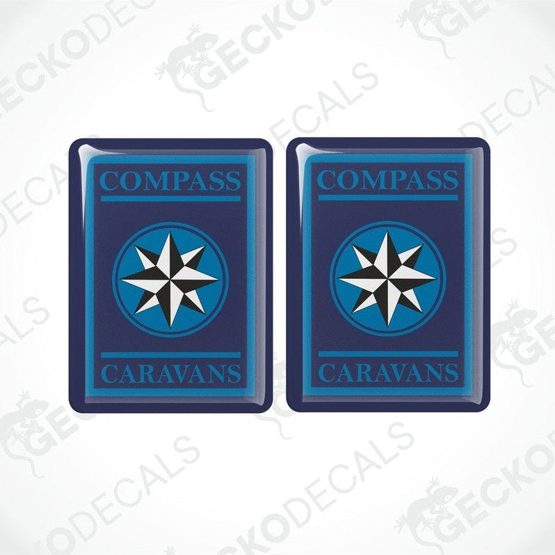 Two blue vinyl stickers with a white compass design and the word 'CAMPERVANS' printed on them.