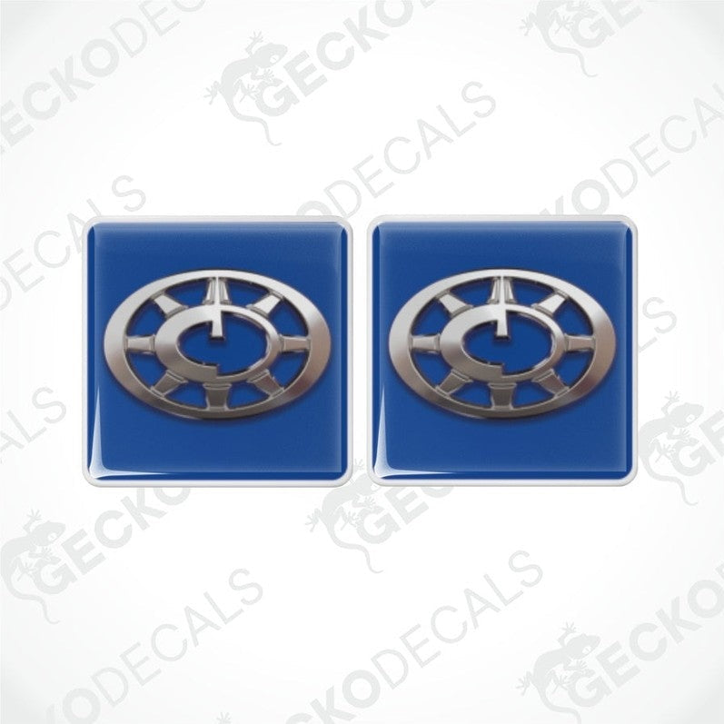 Two blue vinyl decals with a silver compass design, intended for use as stickers on vehicles.