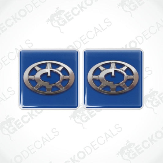 Two blue vinyl decals with a silver compass design, intended for use as stickers on vehicles.