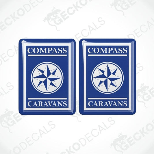 Two blue vinyl decals with a white compass design and the text 'COMPASS CARAVANS' on them.