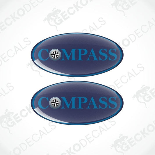 Two blue vinyl stickers with the word 'COMPASS' and a logo depicting a star and a half-moon, surrounded by a white border.