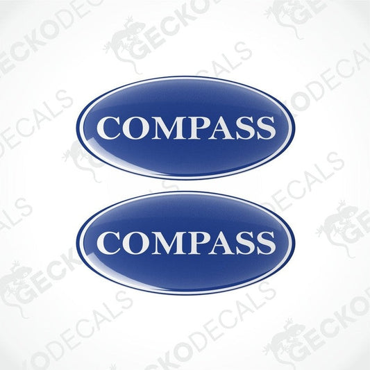 Two blue vinyl stickers with the word 'COMPASS' printed on them.