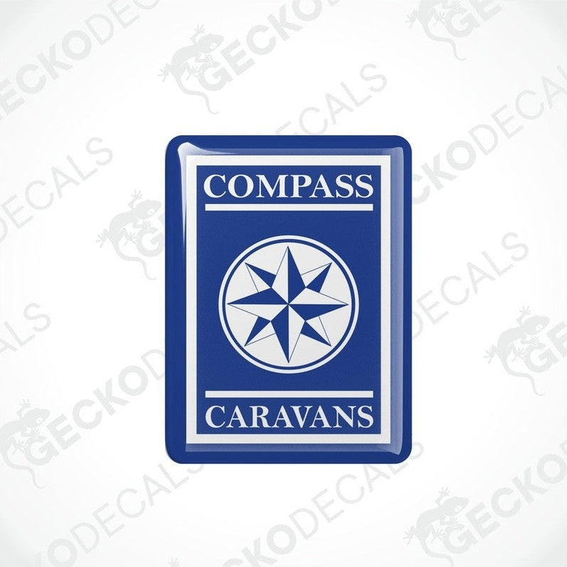 Two blue vinyl decals with a white compass design and the text 'COMPASS CARAVANS' on them.
