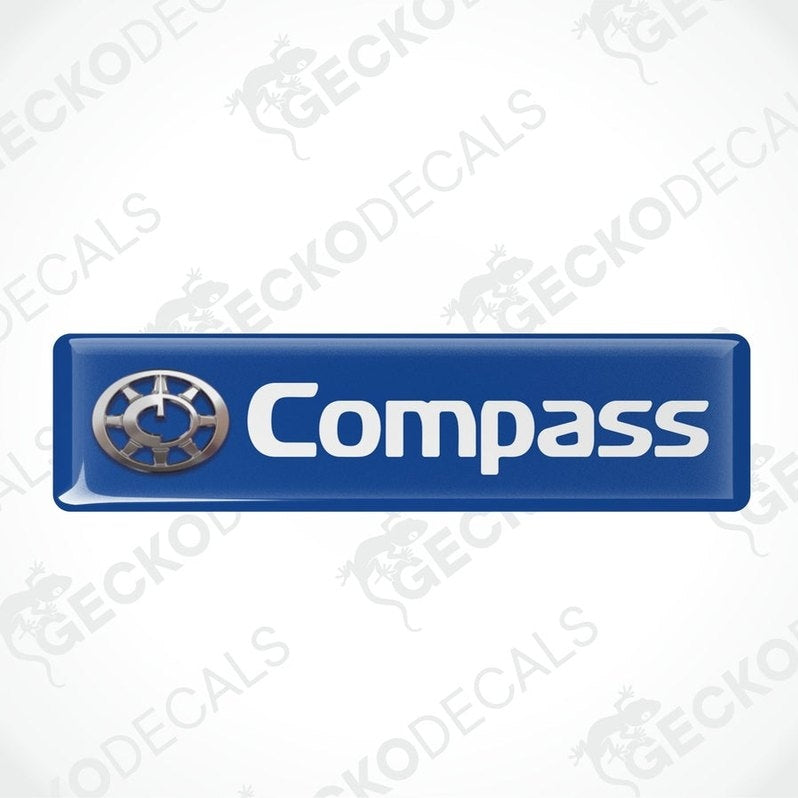 Two blue vinyl stickers with a compass logo, designed for use on vehicle windows.