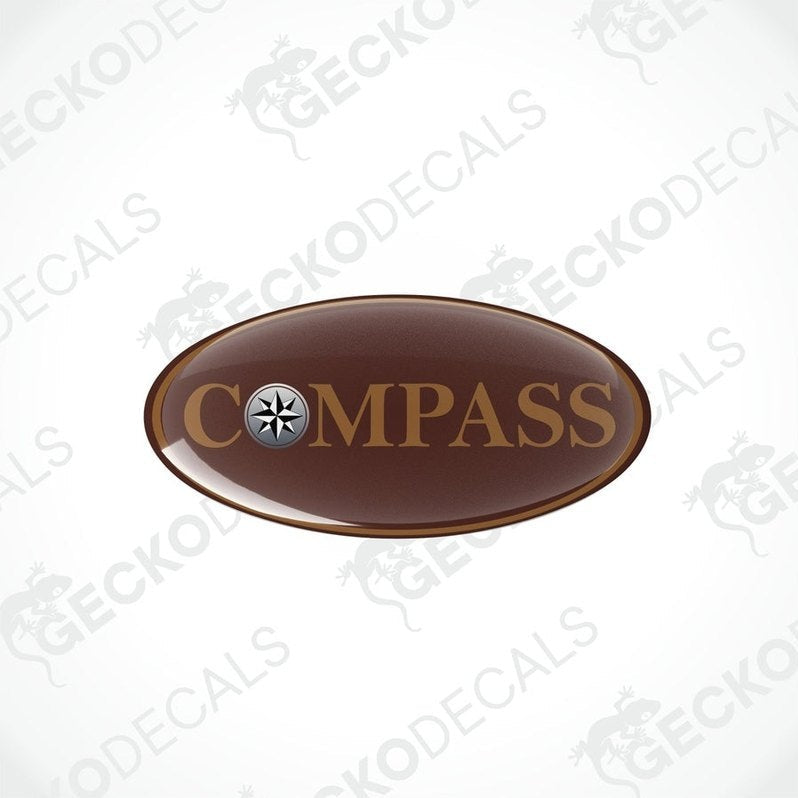 Two brown oval-shaped vinyl decals with the word 'COMPASS' printed on them, including a compass symbol within the text.