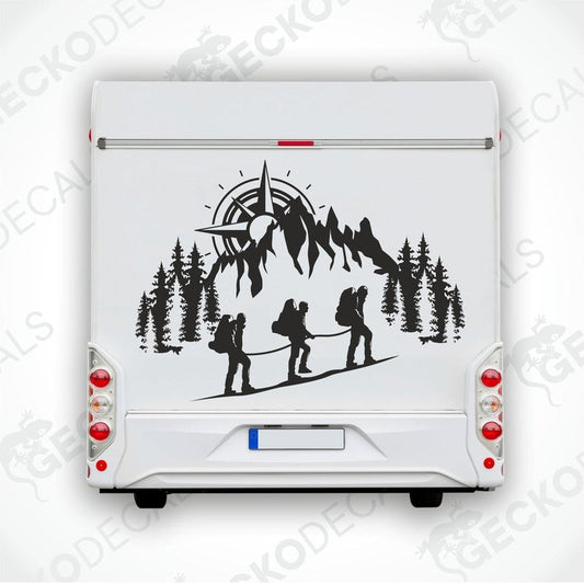 A black and white decal of a compass and people climbing a mountain.