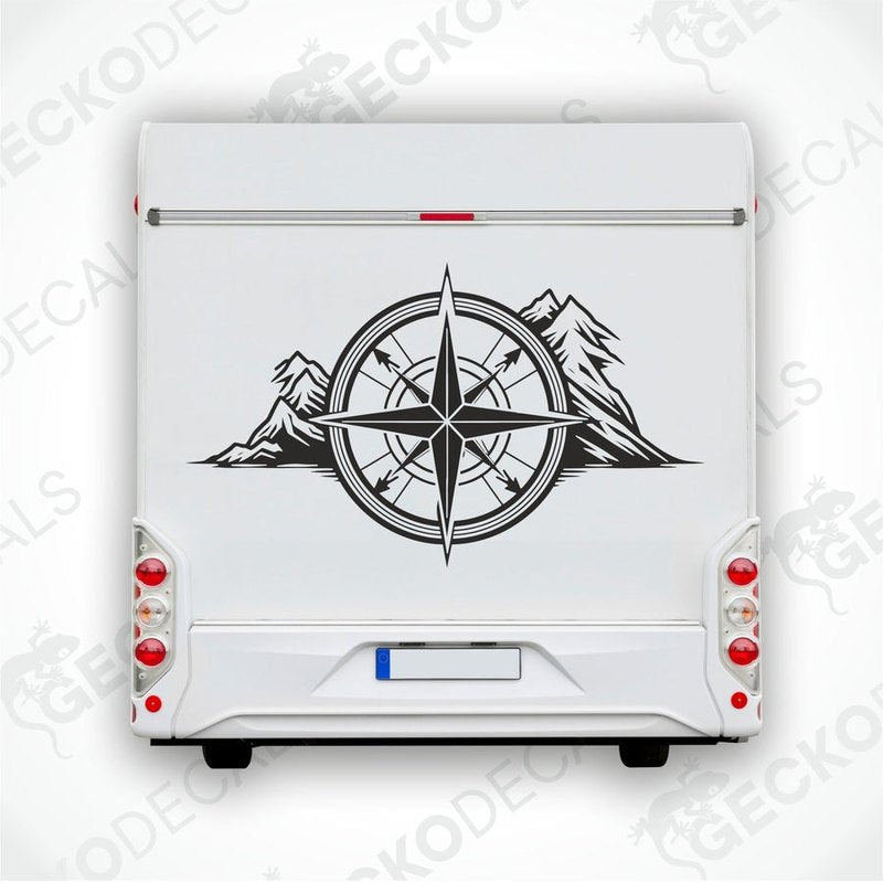 A white vehicle decal featuring a black compass design with mountains around it.