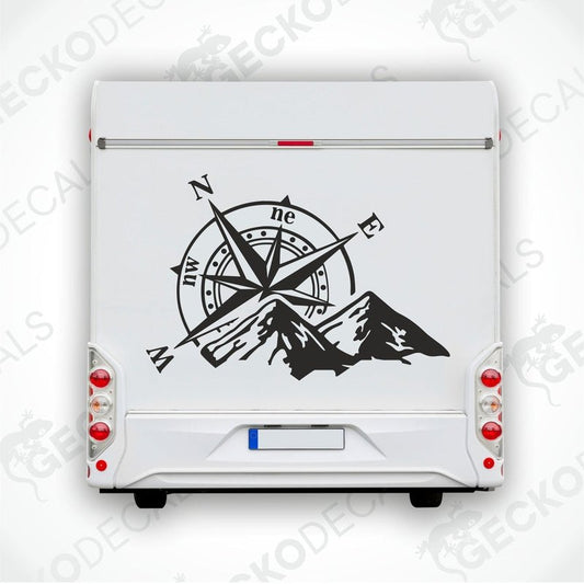 Black Compass Mountain RV decal applied to rear door showing directional markers and rugged peaks